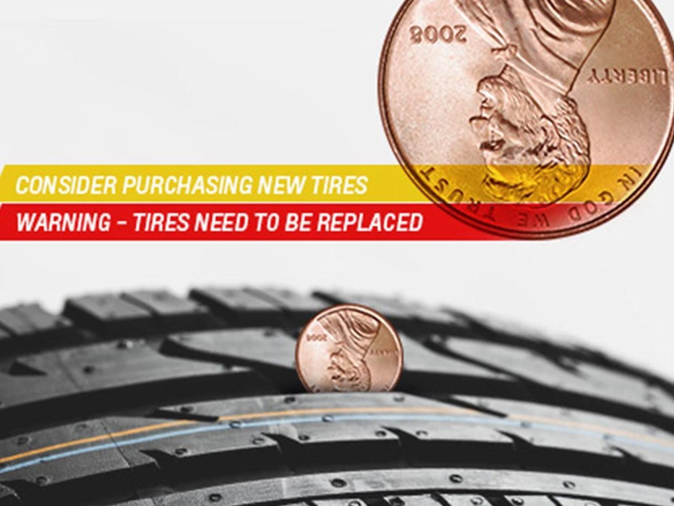 Showing how to check tire tread by using a penny